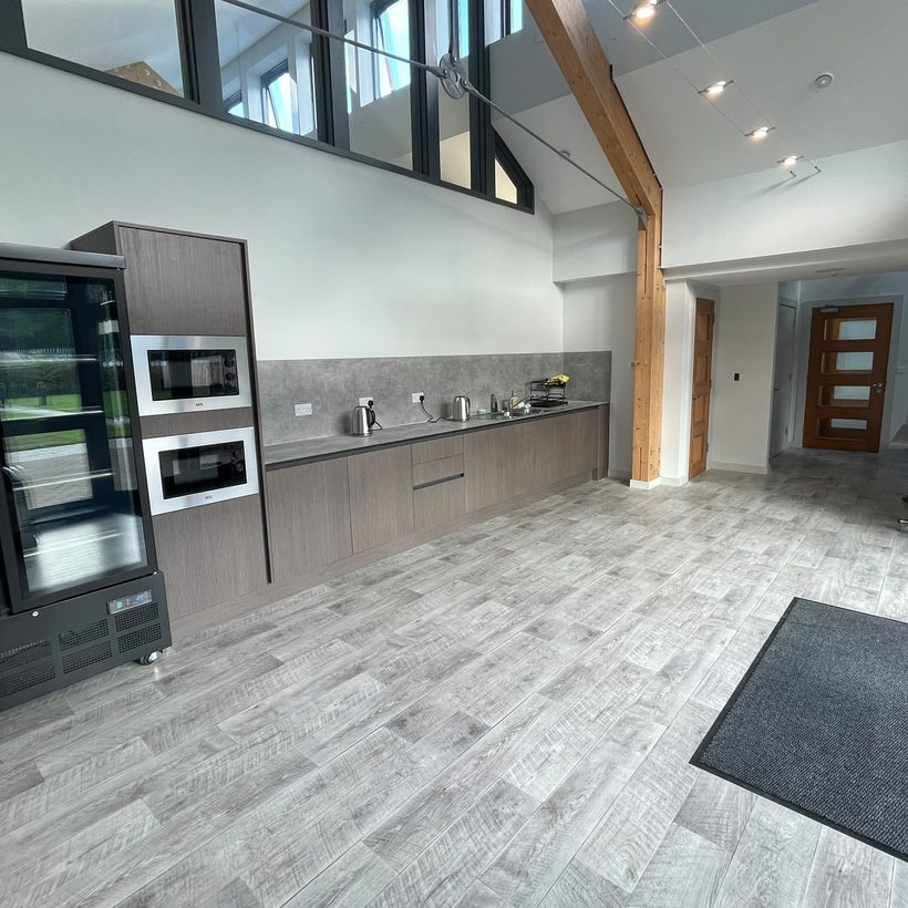 The shared kitchen at Mynydd Awel, with a high timber ceiling